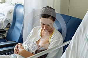 Newborn baby in mother`s arms in photo