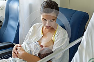 Newborn baby in mother`s arms in photo