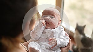 Newborn baby in mothers a arms. Happy family kid dream concept. Mother and son baby close-up lifestyle portrait indoors