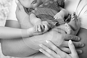 Newborn Baby in parents hands.Mother and fatherhold they newborn baby girl. Parents and they Child. Happy Family concept. Close up