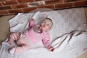 newborn baby in pink clothes in a crib, the concept of children and birth