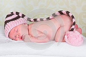 Newborn baby with pompom hat