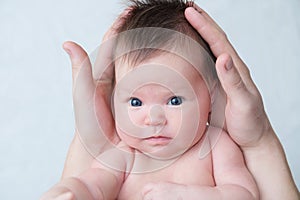 Newborn baby portrait in fathers hands, happy fatherhood