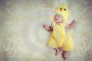 Newborn baby portrait. Happy sleeping lovely cute Asian baby wearing yellow chicken dress suite for Asia Chinese sign zodiac year