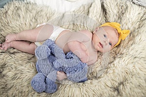 Newborn baby posing for her first portrait.