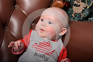 Newborn baby in red and gray jumpsuit