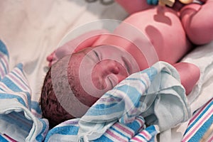 Newborn baby resting in delivery room