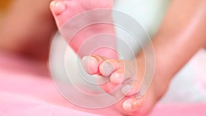 Newborn Baby`s feet. Mother holding newborn baby legs,