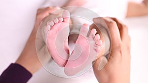 Newborn Baby`s feet in mother`s hands