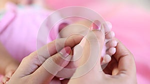 Newborn Baby`s feet in mother`s hands