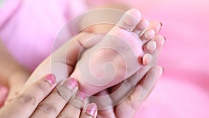 Newborn Baby`s feet in mother`s hands