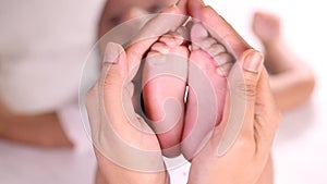 Newborn Baby`s feet in mother`s hands