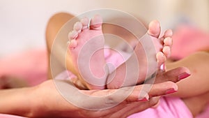 Newborn Baby`s feet in mother`s hands