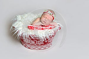 Newborn baby in santa claus bonnet