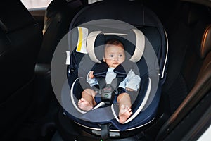 newborn baby sitting in infant car seat, safety chair travelling