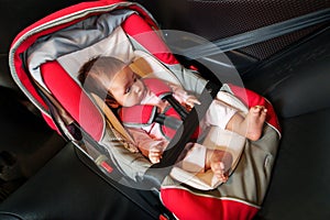 newborn baby sitting in infant car seat, safety chair travelling