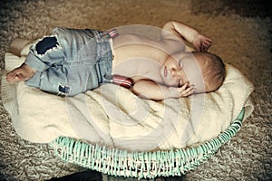 Newborn baby sleep in crib on floor