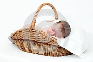 Newborn baby sleeping in basket