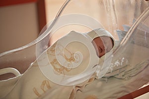 newborn baby sleeping in bed at hospital