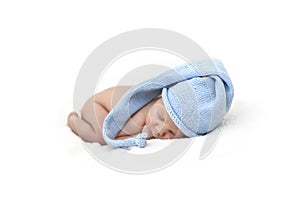 Newborn baby sleeping in a blue cap