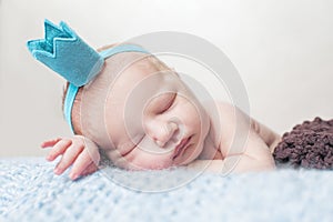 Newborn baby sleeping on blue woolen blanket