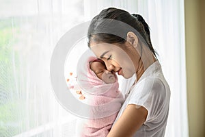 The newborn baby sleeping in the embrace of the mother and the nose collided