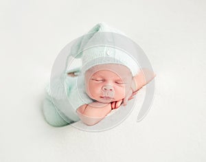 Newborn baby sleeping in mint clothes