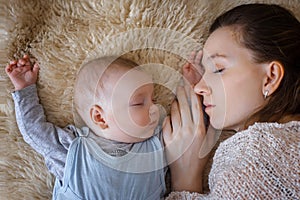 Newborn baby sleeping next to her mother