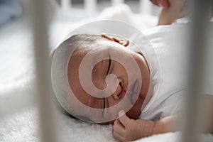 Newborn Baby Sleeping In Nursery Cot