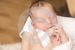 Newborn baby sleeping on sheet