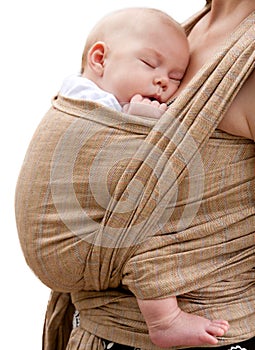 Newborn baby sleeping in a sling,