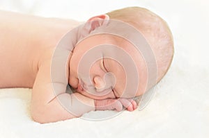 Newborn baby sleeping on white