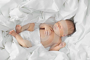 Newborn baby sleeping on white blanket