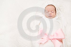 Newborn Baby Sleeping On White, New Born Girl Wrapped With Ribbon Bow