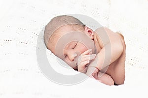 Newborn baby sleeps and smiles