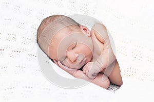 Newborn baby sleeps and smiles