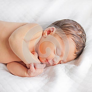 Newborn baby sleeps and smiles