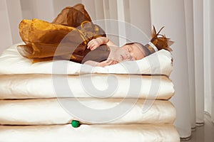 Newborn baby sleeps on white mattresses and green pea. Time to sleep for infant
