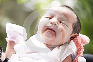 Newborn baby smiling in mother`s hands, selective focus in her eyes, Family concept