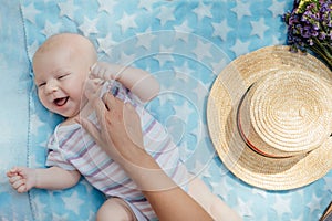 Newborn baby spending time outside. Happy and smiling mother with her newborn baby spending time in the park. Getting