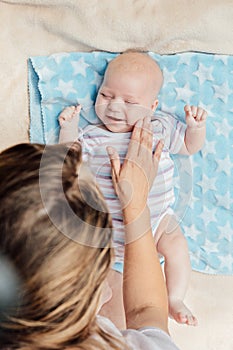 Newborn baby spending time outside. Happy and smiling mother with her newborn baby spending time in the park. Getting