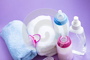 Newborn baby story. Towels and children's toys, scissors, baby bottle, nipple, hairbrush on white background