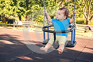 Newborn baby swing play park outdoor summer playground photo