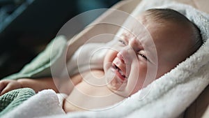newborn baby swinging in a rocking chair. happy family kid dream concept. baby newborn close-up looking at the camera
