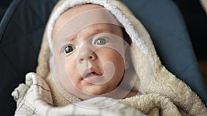 newborn baby swinging in a rocking chair. happy family kid dream concept. baby newborn close-up looking at the camera