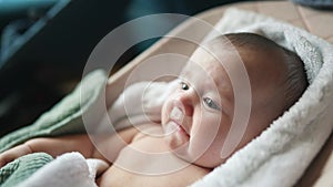 newborn baby swinging in a rocking chair. happy family kid dream concept. baby newborn close-up looking at the camera