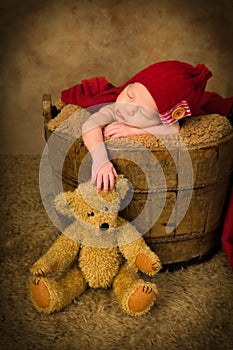 Newborn baby and teddy bear