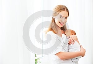Newborn baby in tender embrace of mother