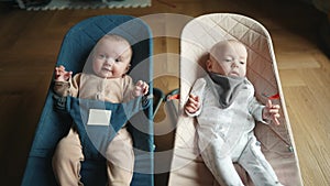 Newborn baby twins in a rocking chair. Happy family kid dream concept. Portrait twins newborn baby child. Twins baby