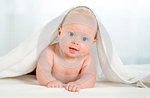 Newborn baby under the white towel